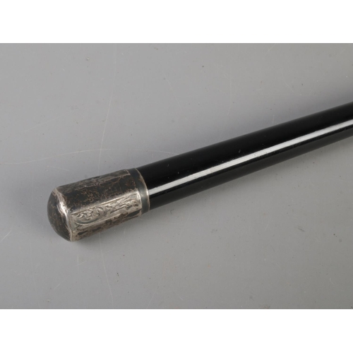 606 - A silver mounted and ebonised conductor's baton. The mounts assayed for Birmingham and London, 1934 ... 