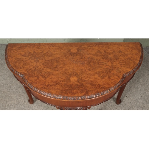 622 - A walnut fold over side/games table. Raised on carved cabriole supports.