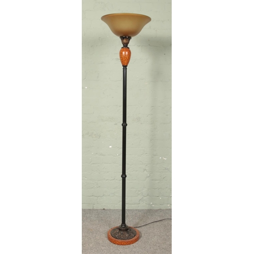 626 - A black metal and faux marble uplighter/standard lamp.