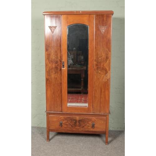 628 - A Victorian three piece walnut bedroom suite to include wardrobe, dressing table and chest of drawer... 