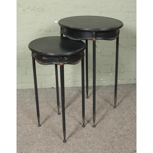 630 - A nest of two slender metal side tables. Height of tallest: 76cm.