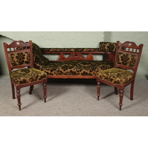 633 - A Victorian carved mahogany chaise lounge along with two matching salon chairs.