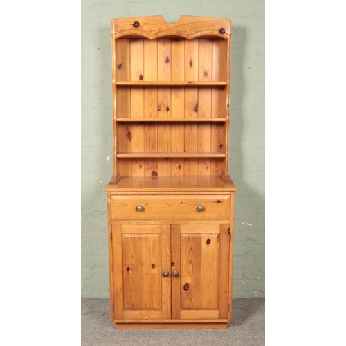 634 - A slender pine kitchen dresser. Height 190cm, Width 76cm, Depth 47cm.