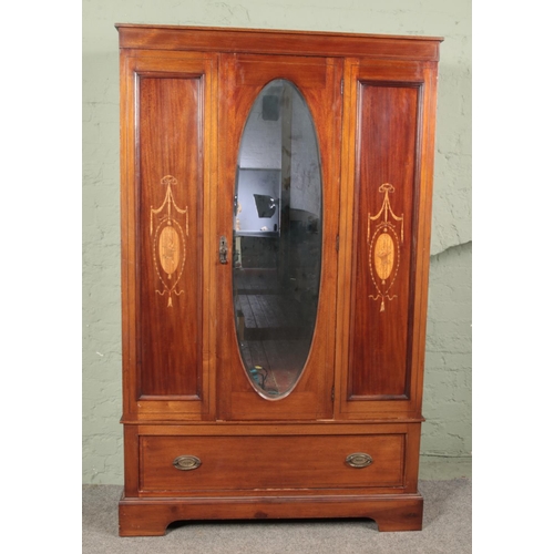 638 - A Victorian inlaid mahogany mirror front wardrobe.