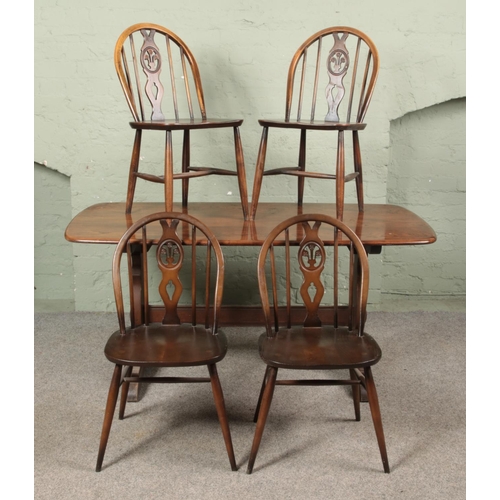 639 - An Ercol refectory style table along with four Ercol Fleur De Lis dining chairs. Table top 150cm x 7... 