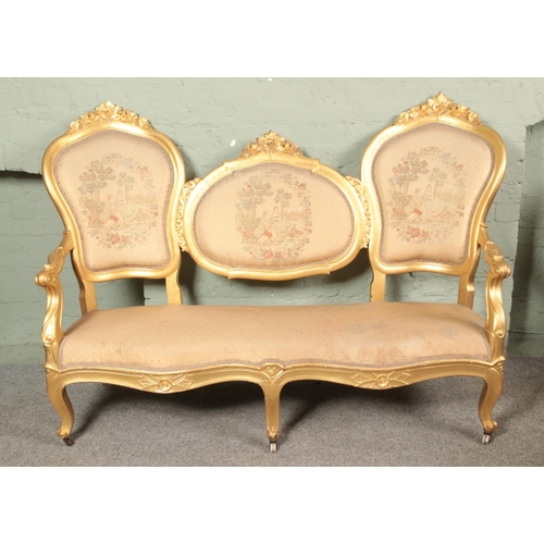 640 - An Italian gilt wood conversation style sofa. Having embroided decoration to the back rests depictin... 