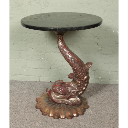 642 - A decorative side table with faux marble top and dolphin support. Height 72cm.