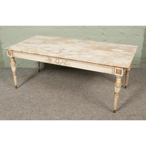 645 - A marble top coffee table raised on painted wooden base. Length 111cm.