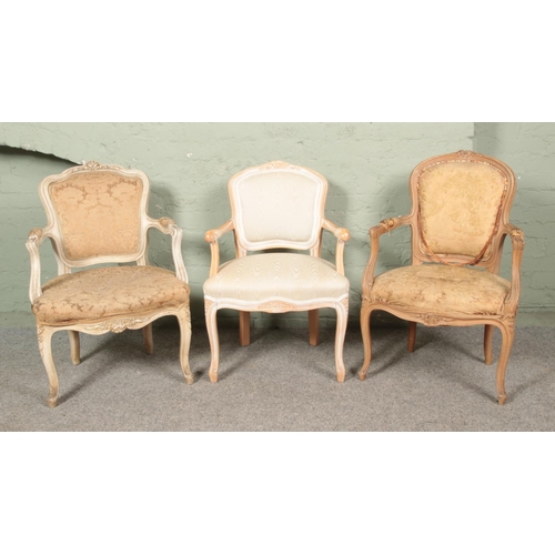 648 - Three French/Continental style upholstered arm chairs.