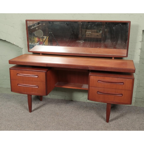 653 - A G-Plan Fresco teak floating top dressing table with mirror. Approx. dimensions 153cm x 46cm x 119c... 