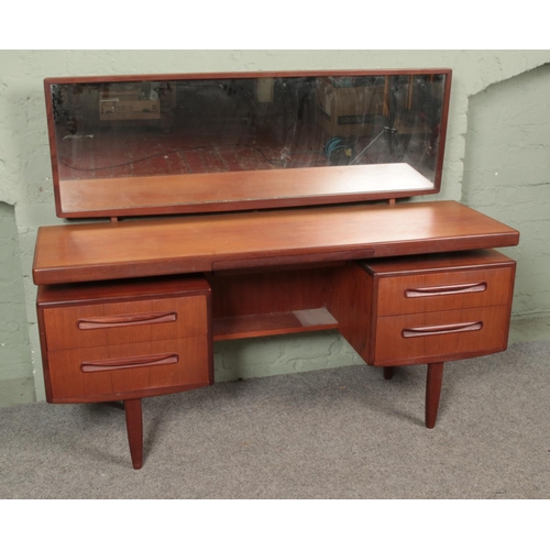 653 - A G-Plan Fresco teak floating top dressing table with mirror. Approx. dimensions 153cm x 46cm x 119c... 