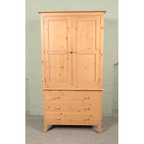 657 - A solid pine wardrobe with double panelled door and 4 drawers, width 102 x depth 62 x height 195 cm