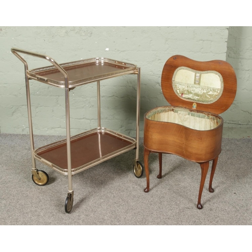 659 - A small kidney shaped sewing box along with a two tier folding drinks trolley with removable trays.