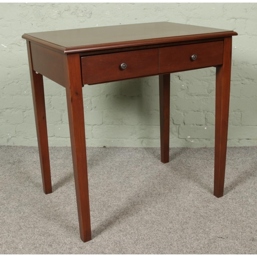 662 - A side table raised on square cut legs. Having drawer with drop down front.