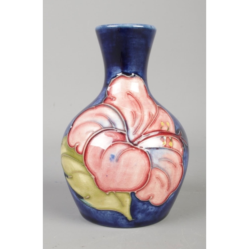 90 - A petite Moorcroft bud vase, in the Hibiscus pattern. Height: 9cm.