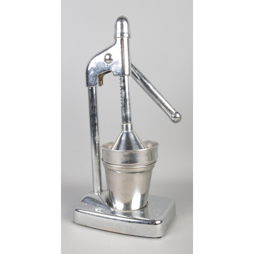 95 - A mid-century chrome and stainless steel table top juicer. Height: 39cm.