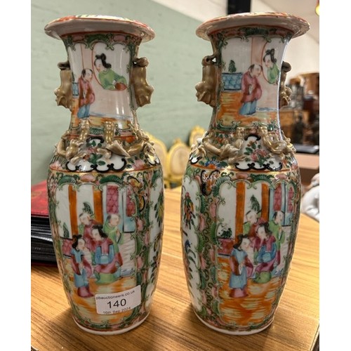 140 - A pair of 19th century Chinese Cantonese famille rose vases. 

Hx26cm