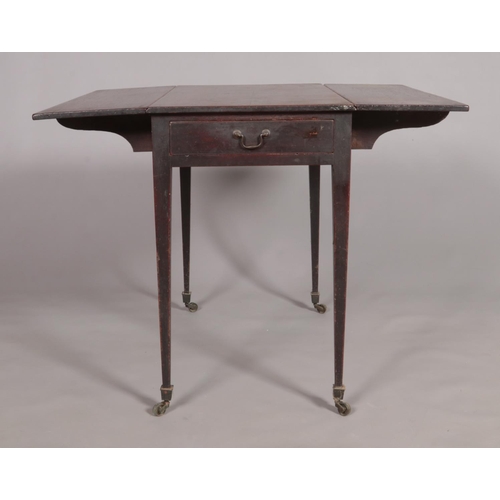 453 - A Georgian mahogany pembroke table with single drawer and tapering supports.