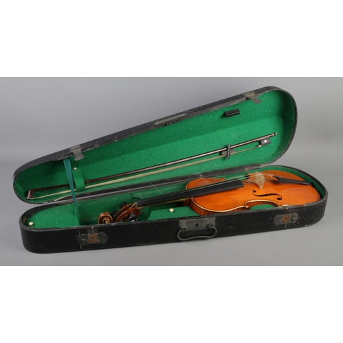 86 - A wooden cased violin with bow. Having two piece 14 inch back.