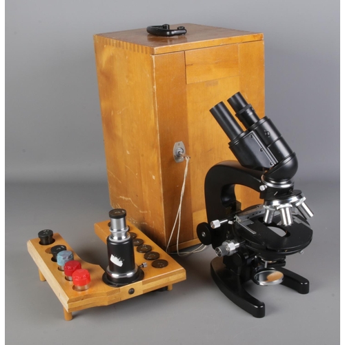 105 - A cased Russian AY-12 CCCP binocular microscope with fitted tray containing ten lenses of varying si... 