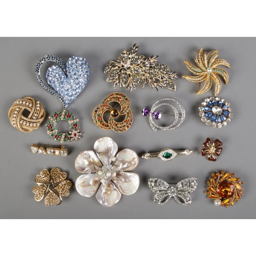 110 - A collection of costume jewellery brooches of mainly a floral theme to include mother of pearl examp... 