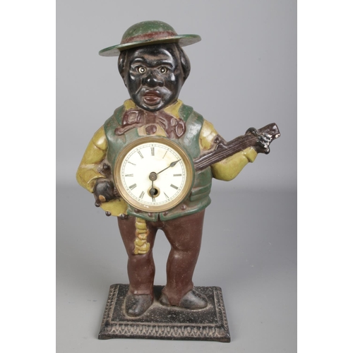 133 - A painted cast iron novelty figural mantel clock formed as a gentleman playing the banjo, possibly A... 