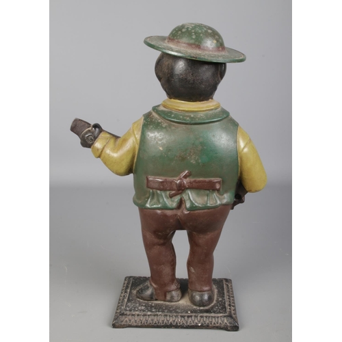 133 - A painted cast iron novelty figural mantel clock formed as a gentleman playing the banjo, possibly A... 