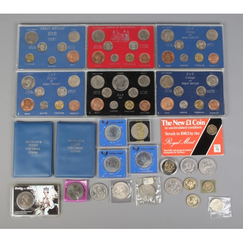 14 - A quantity of uncirculated coin packs 1960-1965, together with a collection of commemorative coins a... 