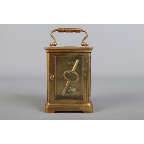 2 - Gilt brass cased carriage clock,  loop handle with bevelled edge glass panels, open escapement and w... 