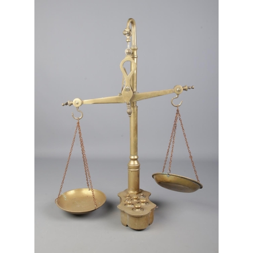 21 - A set of DLC Italy brass balance scales with inset weights.