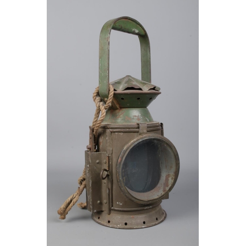 22 - A WWII C. Eastgate & Sons, Birmingham railway lantern. Dated 1943 and bearing broad arrow mark to th... 