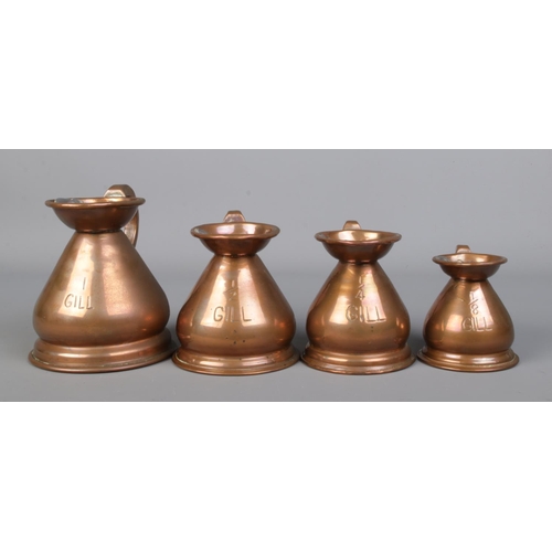 27 - A set of four graduated copper jugs, all bearing lead stamps to the rim, 'HR'. 1 Gill, 1/2 Gill, 1/4... 