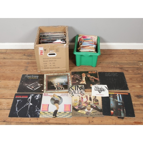 201 - Two boxes of assorted vinyl records and singles of mainly rock and pop to include Depeche Mode, ACDC... 