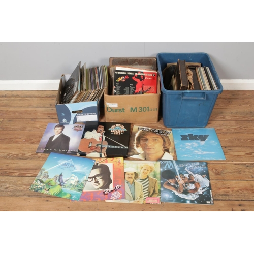 217 - A large collection of records including Rick Astley, Elvis Presley, Barry Manilow, Sky, Boney M, Bud... 