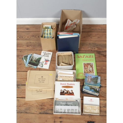 233 - A quantity of stamps and postcards, includes albums etc