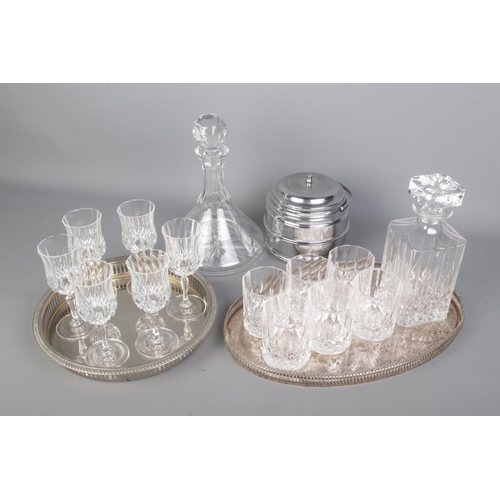 38 - Two Cut Glass/Crystal Decanter Sets, both with six cups and silver plated salver, comes with a ice b... 