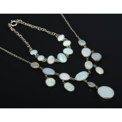 344 - A white metal jewellery suite containing necklace and bracelet featuring oval opal plaques.