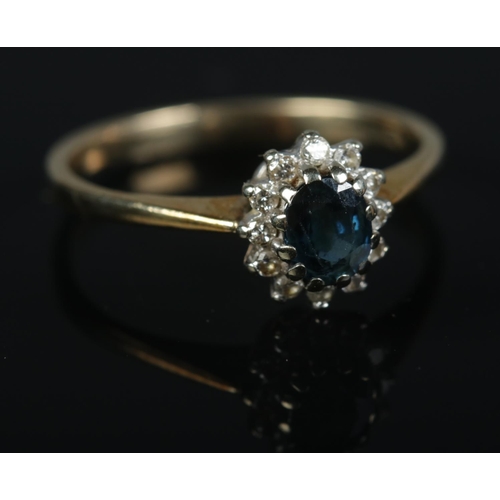 351 - A 9ct gold sapphire and diamond halo ring size N, 1.9g.