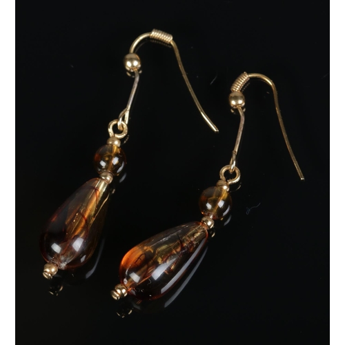 376 - A vintage pair of yellow metal and faux amber drop earrings