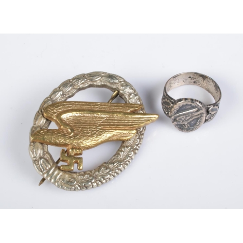 396 - A German WWII Third Reich Fallshirmjaeger Luftwaffe Paratrooper badge and ring (possibly silver). No... 