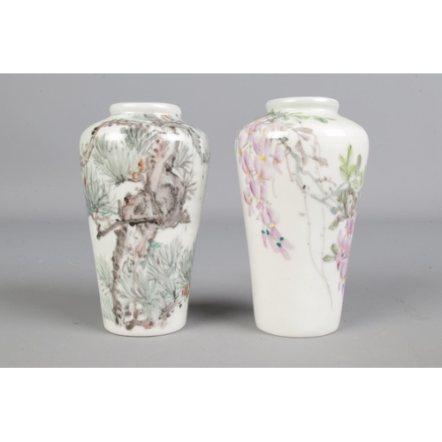 416 - A pair of miniature Chinese high shouldered vases, hand painted with flowers and trees. Height 9cm.