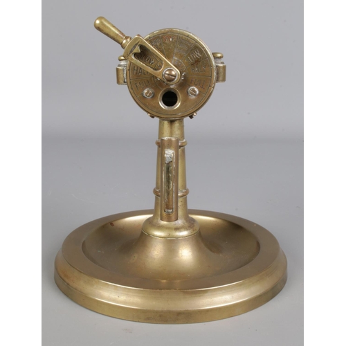 418 - An early Twentieth century brass cigar cutter and ashtray, in the form of a ship's telegraph.