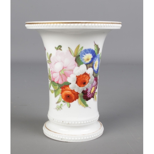 423 - A Rockingham style trumpet vase with hand painted floral decoration. Height 12.5cm.