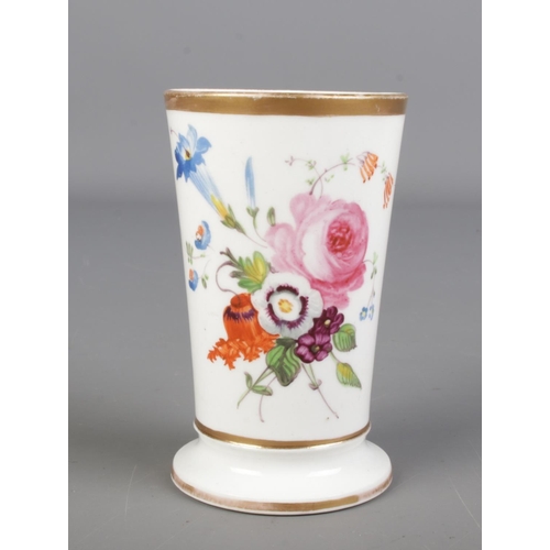 424 - A Rockingham style vase of tapering form, hand painted with floral decoration. Height 10cm.