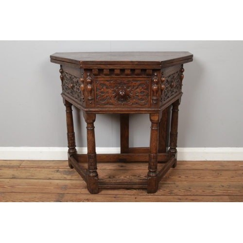 442 - An oak carved credence fold over side table with gate leg to back, strapwork decoration with central... 