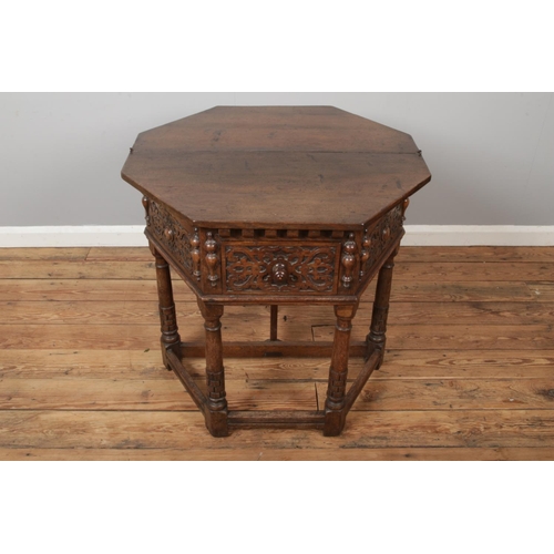 442 - An oak carved credence fold over side table with gate leg to back, strapwork decoration with central... 