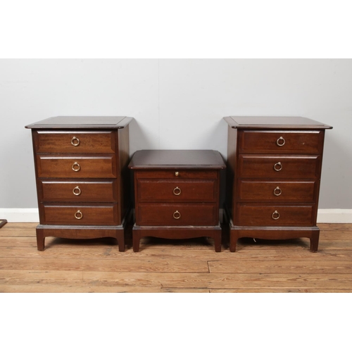 444 - A pair of Stag bedside cabinets each having four drawers with another smaller Stag bedside cabinet.