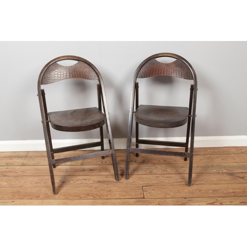 447 - A pair of bentwood folding chairs with faux crocodile skin seat.