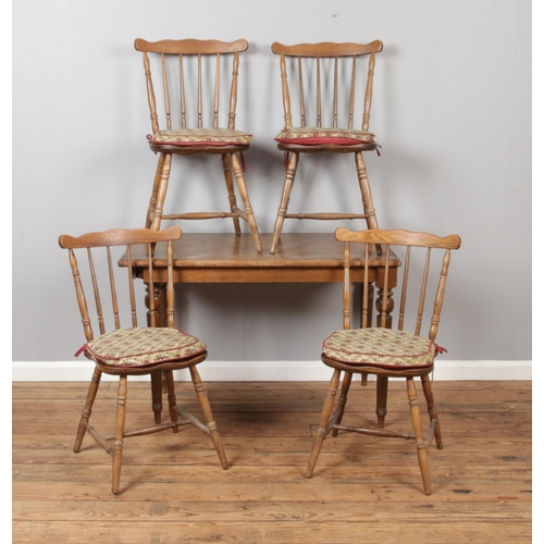 448 - An oak table with a set of four spindle back chairs