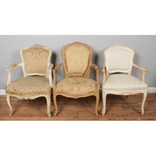 462 - Three French/Continental style upholstered arm chairs.